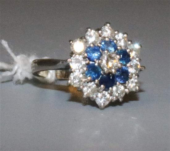 A white gold, sapphire and diamond cluster ring, size H.